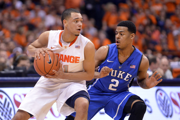 Feb 1, 2014; Syracuse, NY, USA; Syracuse Orange guard Tyler Ennis (11) looks to dribble past Duke Blue Devils guard Quinn Cook (2) during the first half of a game at the at Carrier Dome. Syracuse won the game 91-89.