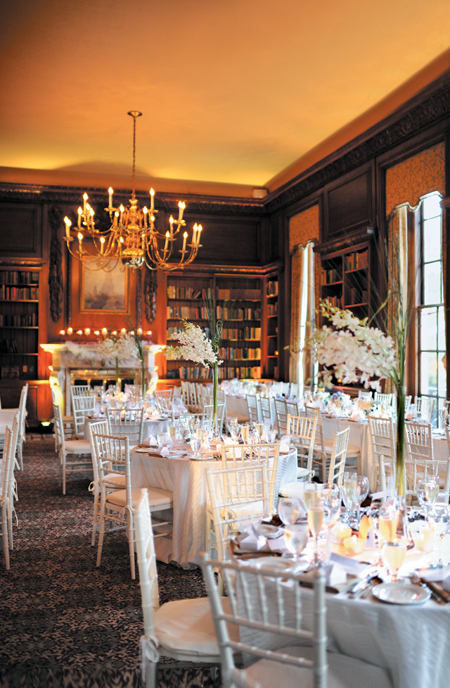 A lush, candlelit wedding in a library or bookstore