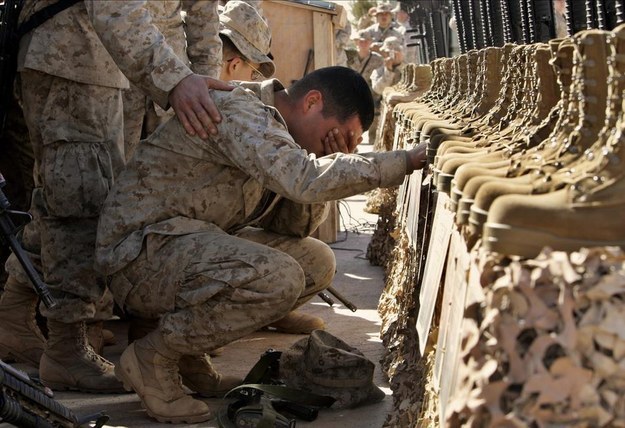 Um fuzileiro naval dos Estados Unidos chora durante um serviço memorial por 31 militares norte-americanos mortos perto de Rutbah, no oeste do Iraque. 2 de fevereiro de 2005.