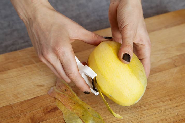 Cutting a mango can be tricky. Start by peeling the skin off.