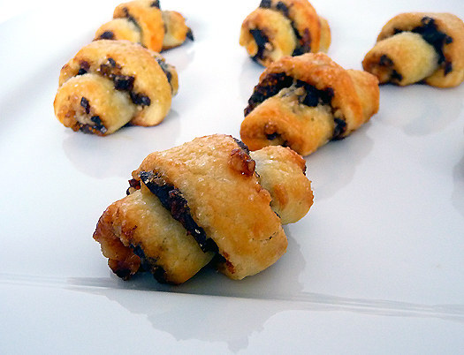 Sugary, buttery goodness. Rugelach are Jewish pastries made with cream cheese dough wrapped around a sweet filling, like chocolate or jam. Then, these crescent shaped cookies are baked to perfection. SUCH BEAUTY. Recipe here:http://www.justataste.com/2010/12/chocolate-rugelach/