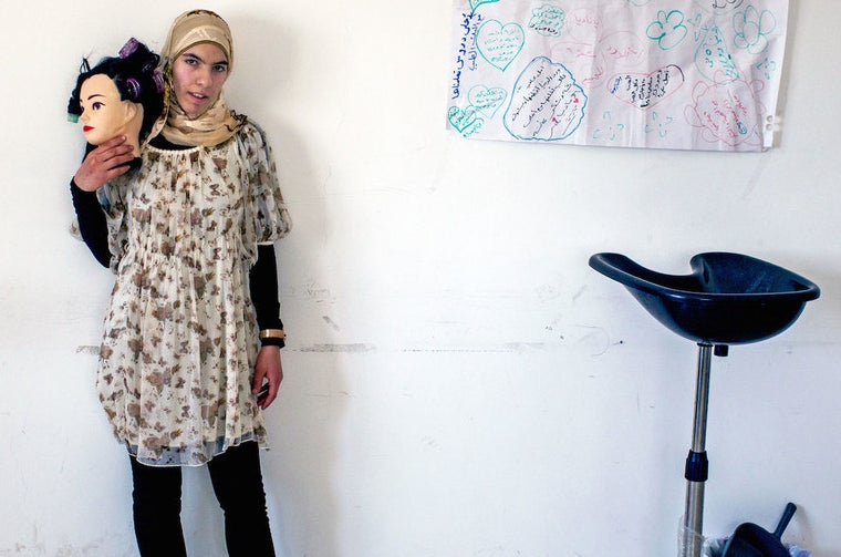 Raghad stands in the classroom where the women learn about make-up