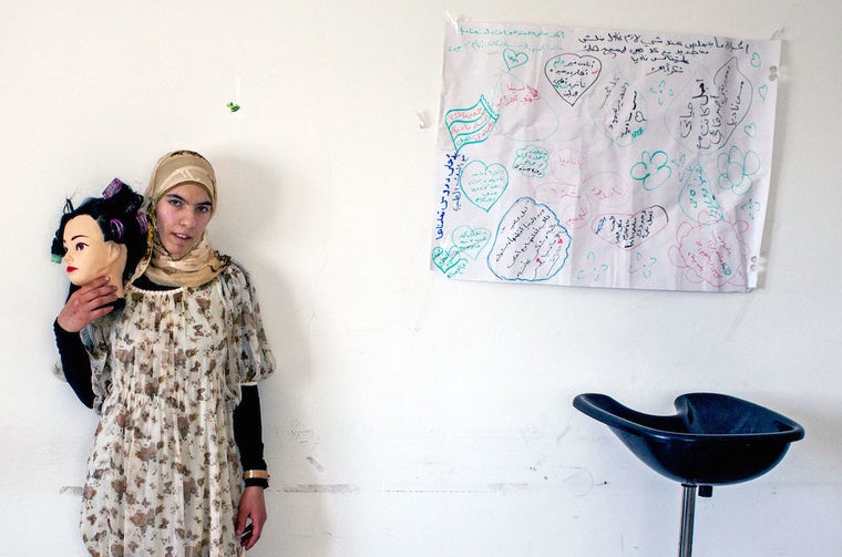 Raghad stands in the classroom where the women learn about make-up