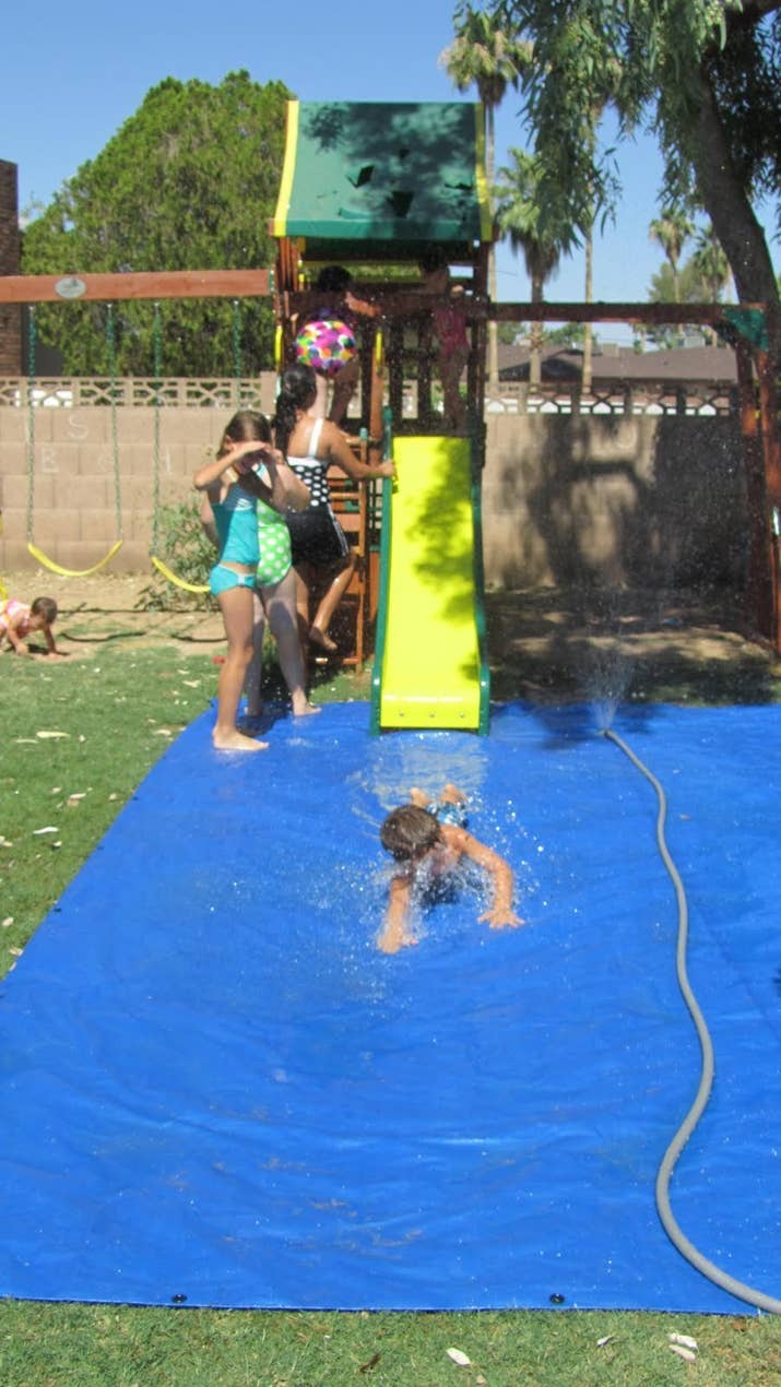 The sprinkler keeps the tarp wet for a full day of fun splashing.