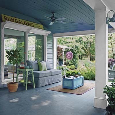 Take a few indoor comforts with you when you go outside this season. Create your own cool breeze with a porch ceiling fan. And, don't limit yourself to outdoor furniture that's hard plastic. Go for plush, weatherproof seating and brightly-painted end tables. While you're at it, throw down an outdoor rug, a few planters, and a coffee table. Now, just look at all the livable space you just added to your house for the summer. Take a tour of the rest of this outdoor space.