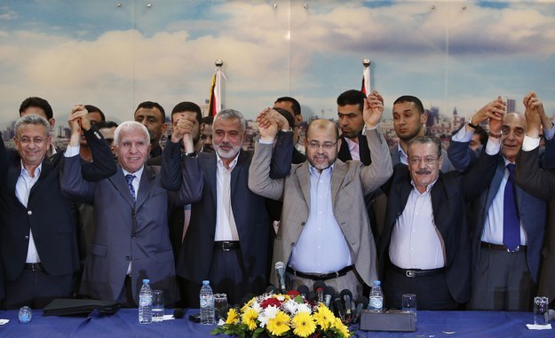 Senior Fatah and Hamas officials celebrate the new unity government.