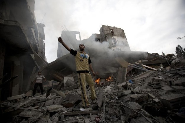 A Palestinian man reacts in the aftermath of an Israeli air strike in Gaza City.
