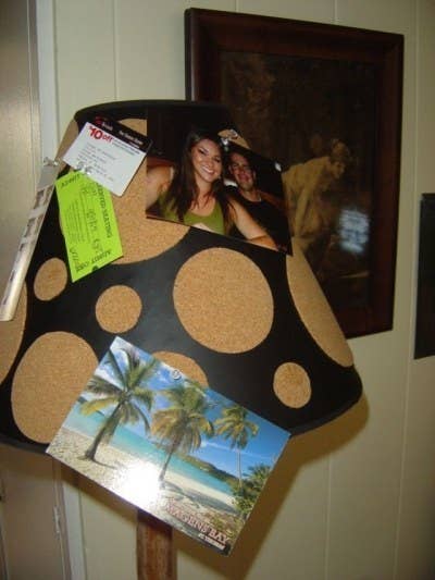 All you have to do is apply latex spray paint and adhere self-adhesive cork circles to the shade.