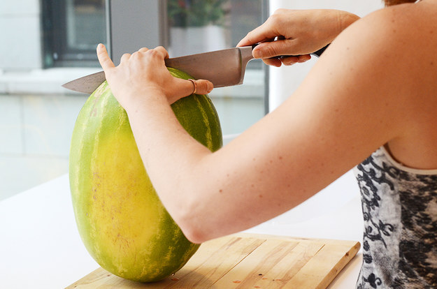 First, cut your watermelon in half, lengthwise.