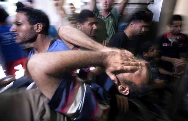 A relative of four young boys from the Bakr family killed on a Gaza beach in an Israeli bombardment cries at the morgue of the al-Shifa hospital in Gaza City on July 16.