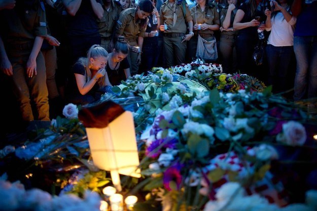 Israelis mourn over the grave of Staff Sgt. Daniel Pomerantz during his funeral in Kfar Azar near Tel Aviv, Israel, on Thursday.