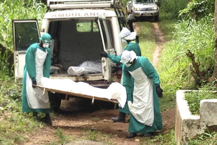 Health workers carry the body of an Ebola virus victim in Kenema, Sierra Leone, in June. Neighboring Liberia is also struggling with the disease, which was first documented in Guinea in March.