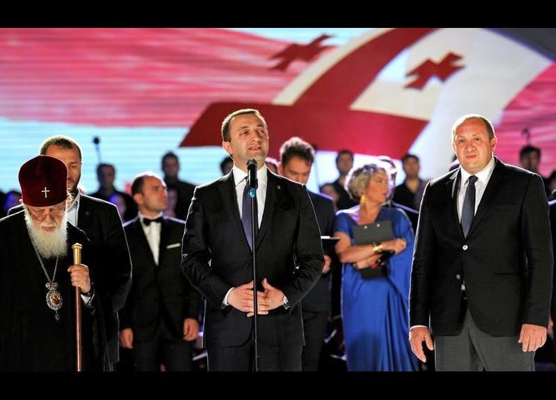 Georgia's prime minister, Irakli Garibashvili (C), speaks alongside the president, Giorgi Margvelashvili (R), and head of Georgia's Orthodox Church, Patriarch Ilia II (L), during celebrations for the signing of an association agreement with the E.U.