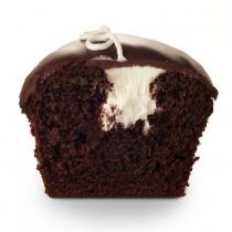 Chocolate cake filled with vanilla buttercream and covered in chocolate ganache icing with a buttercream squiggle on top.