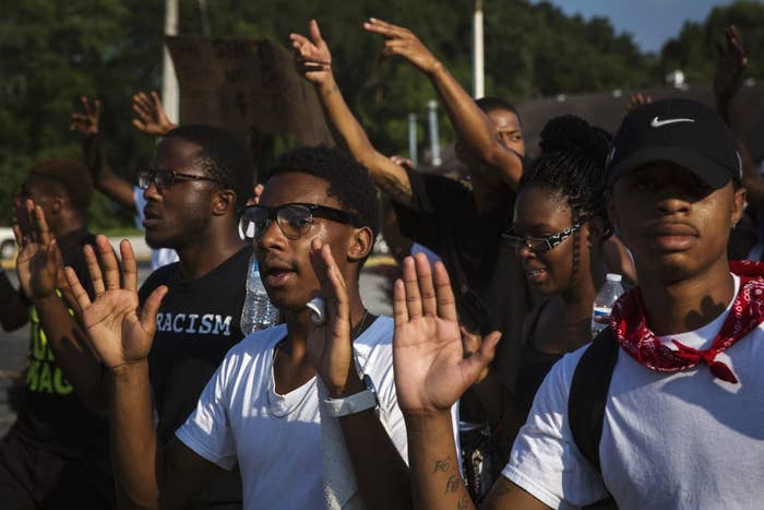Demonstrators march down West Florissant during a march in reaction to the shooting of Michael Brown, near Ferguson, Missouri August 18, 2014.