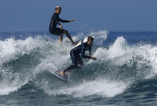 Surfers come close to colliding as they gather off the shore of Solana Beach, California to catch waves being generated out in the Pacific Ocean by Hurricane Marie on Wednesday.
