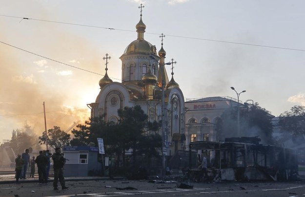 A burned trolley bus lies on a square near a railway station after shelling in Donetsk on Aug. 29.