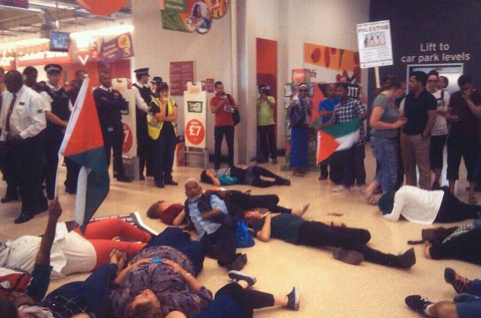 Activists conduct a "die-in" in Sainsbury's in Whitechapel by lying on the floor to represent those who have died in Gaza.