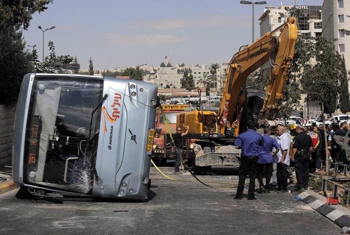 An overturned bus at the scene of a suspected attack in Jerusalem.