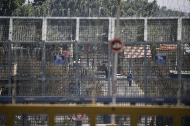 Militants carry water bottles on the Syrian side of the Quneitra border crossing in the Golan Heights on Aug. 31.