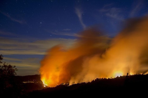 Flames and smoke from the King Fire fill the sky above Fresh Pond yesterday.