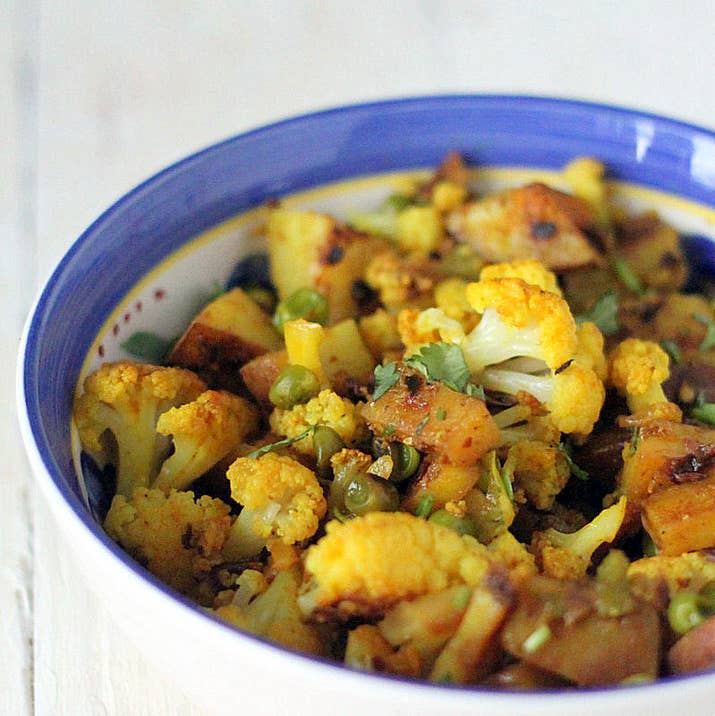 Aloo gobi is a flavorful dish made with potatoes and cauliflower that are cooked in garlic, ginger, turmeric, and other spices. It's typically on the spicier side and is drier because, unlike many main dishes, it isn't served as a stew or in a sauce.Try making it at home with the recipe here.