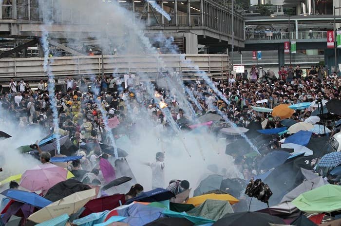 Riot police launch tear gas into the crowd as protesters surround the government headquarters in Hong Kong on Sept. 28.