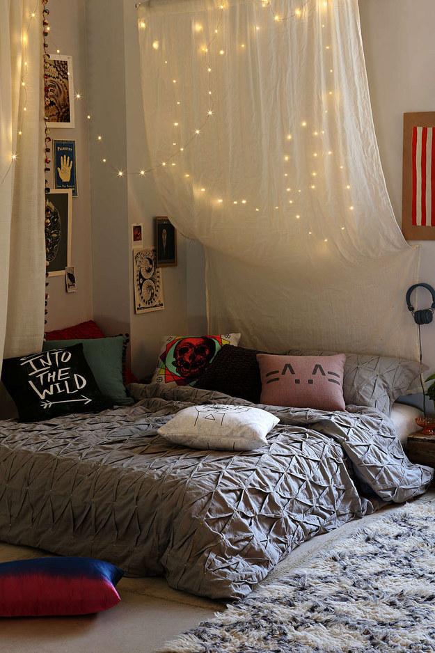 Hang string lights above your bed to add a little magic.