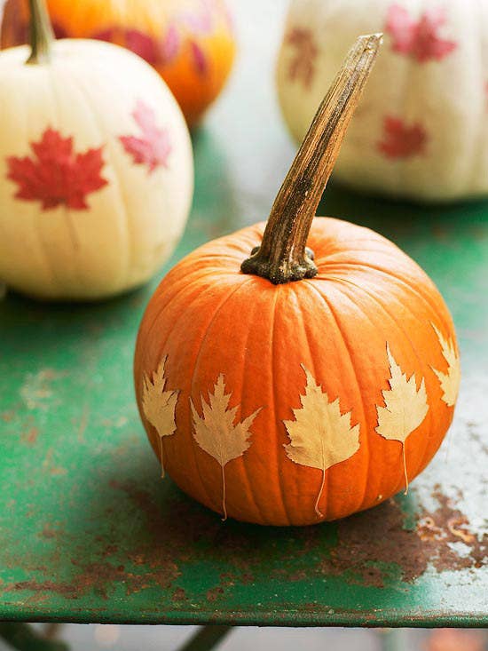 Pimp your pumpkins. Applying leaves to the outside of a white pumpkin makes a beautiful and easy centerpiece for any table.