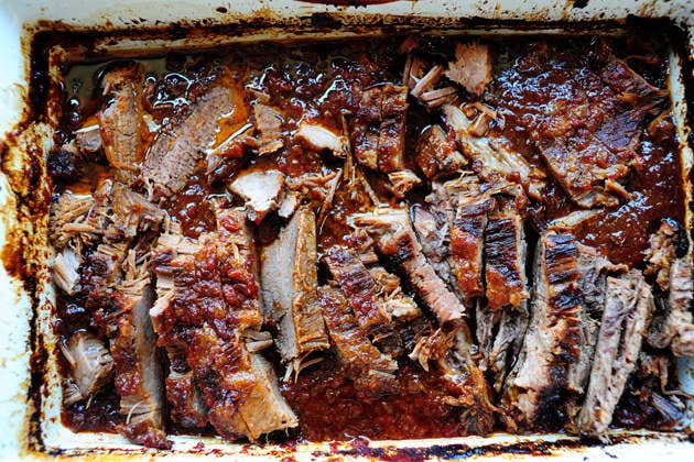 Brisket is made with a cut from the front of the cow, one of the toughest — and back in the shtetls of Eastern Europe, most inexpensive — cuts of meat. To tender it up, it's cooked for hours, whether with with savory herbs and vegetables or sweetened with some brown sugar or dried apricots instead. (Some people also swear by this ketchup + onion soup mix recipe.) However you like to cook your hunk of beef, make sure you give yourself plenty of time — it can take all day.