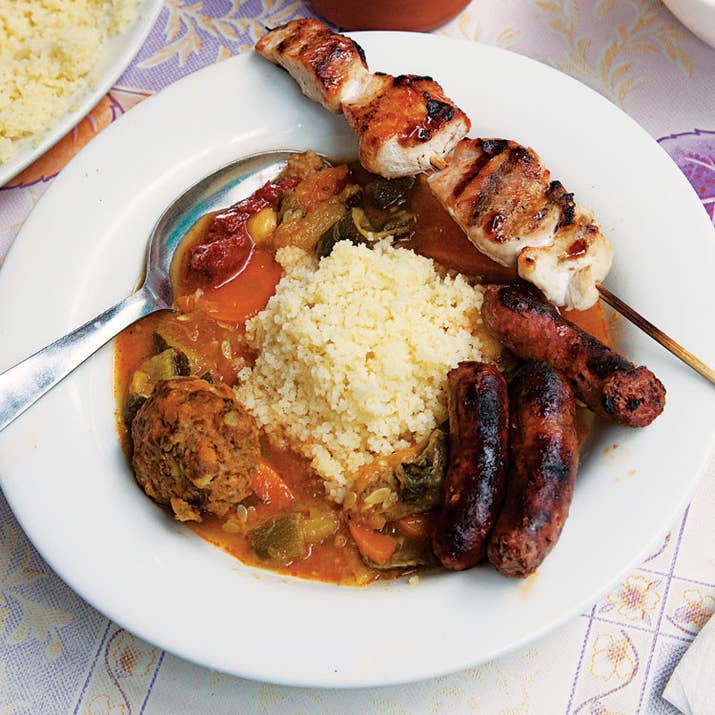 This isn't a "Jewish food" in that only Jews eat it: It's a popular dish in Morocco, Algeria, and Tunisia, and the Jewish communities there love it too. (Because of the large immigrant populations, it has also migrated to Paris.) It's basically couscous with delicious toppings, with those toppings varying regionally and seasonally. This meat-heavy Moroccan version includes chicken, merguez sausages, and lots of lamb. (Kosher Jews should sub in oil for the butter.) It can be made with fish or entirely vegetarian.