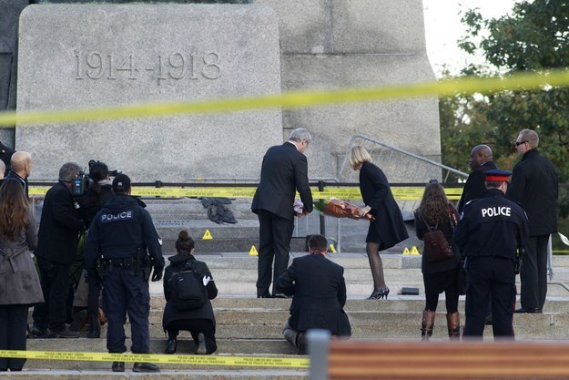 Prime Minister Stephen Harper and his wife, Laureen Harper, lay flowers at the Canadian War Memorial in Ottawa on Thursday.