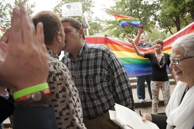 Dr. Jesus Hernandez, left, and Oscar Hull, center, are married by Meredith Sloane outside of Mecklenburg County Register of Deeds office in Charlotte, North Carolina, October 13, 2014.