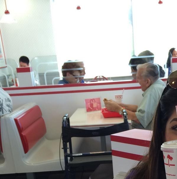 A Picture Of An Elderly Man Eating Alone With A