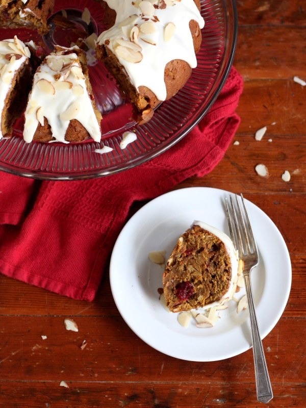 You know how people think you're extra impressive if you bake a cake? If you baked one like this, the effect would double. Pumpkin, cranberries, and almonds, topped with cream cheese icing – learn how to mix them together here.
