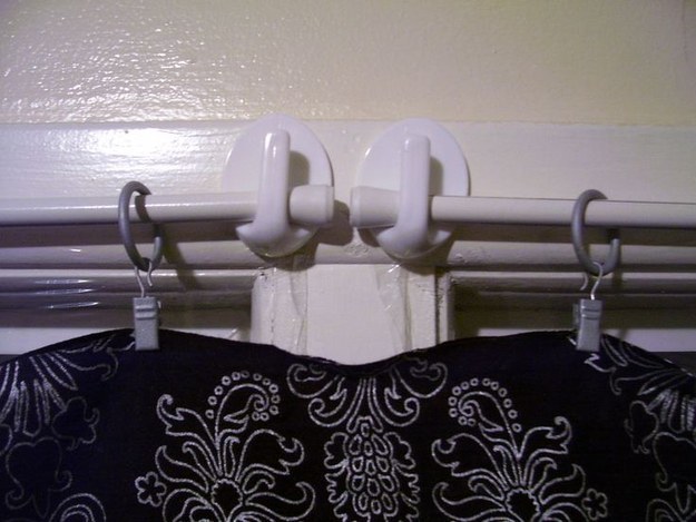 Command hooks holding up makeshift curtain rods in a van or RV