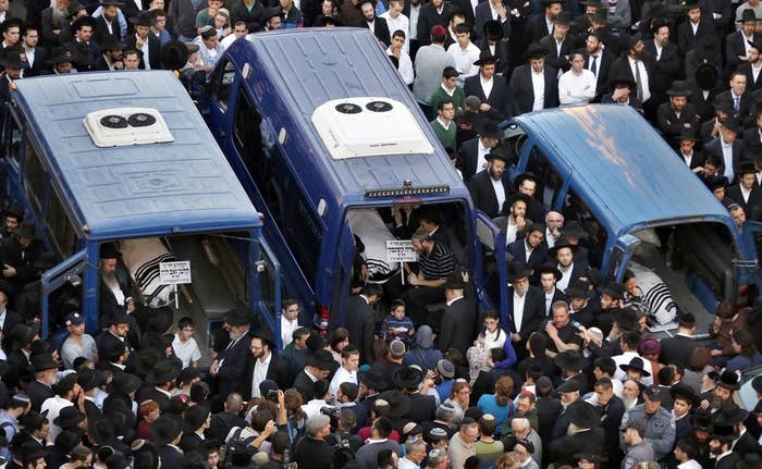 The bodies of three of the victims during their funeral near the scene of the attack on Tuesday.