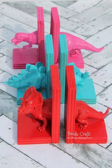 Old toys, paint, scrap wood and hot glue are all you need for this colorful gift. (Consider other plastic figurines you could swap in in place of dinos!)