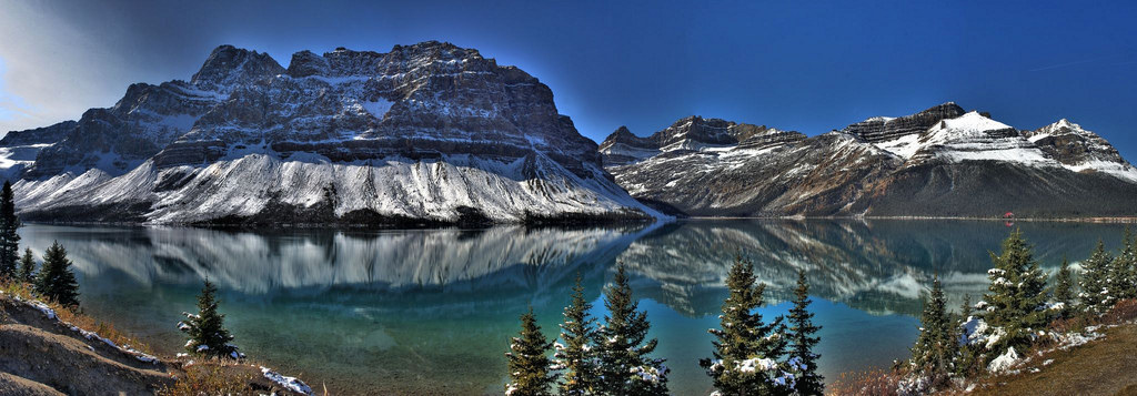 This gorgeous panoramic shot captures Bow Lake in Banff Park and the surrounding Canadian Rockies. .Your face could be here.