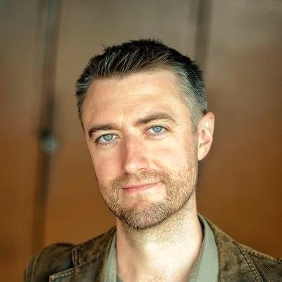 Gunn first appeared as Mick in the series' second episode as a DSL installer. Later in the first season, he is referred to as the 'Swan Man' before finally being introduced as Kirk-- the multi-jobbed, quasi-quarter millionaire.