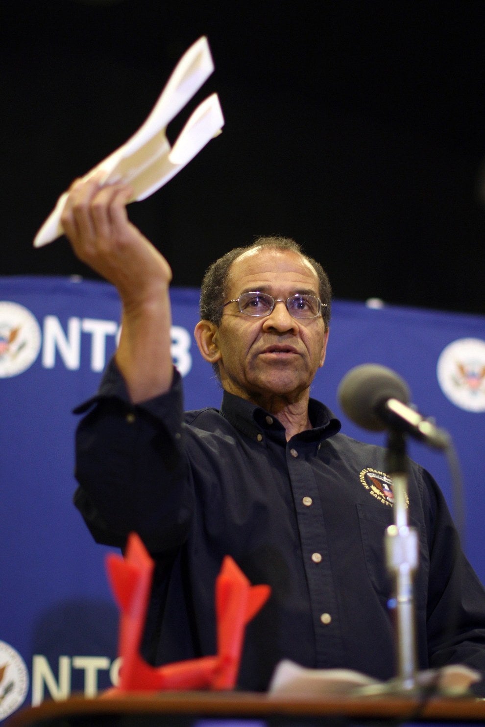 Christopher Hart, acting chairman of the National Transportation Safety Board (NTSB), uses a model during a news conference in Mojave, California.