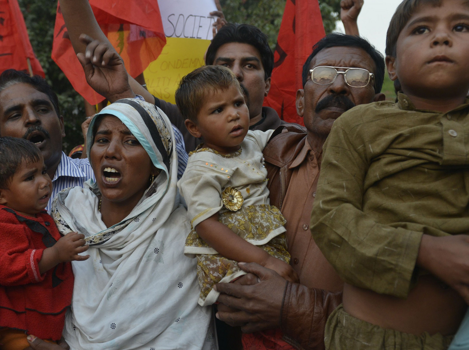 Relatives carry the three children of the slain couple.