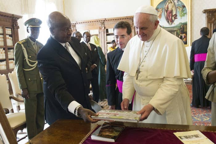 President Yoweri Museveni exchanges gifts with Pope Frances during a private audience at the Vatican October 27, 2014.