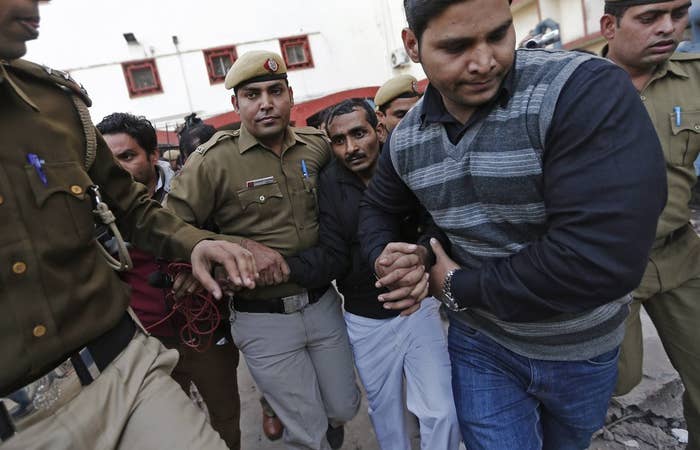 Police on Dec. 8 escort driver Shiv Kumar Yadav (center, in the black jacket) who is accused of raping his Uber passenger.