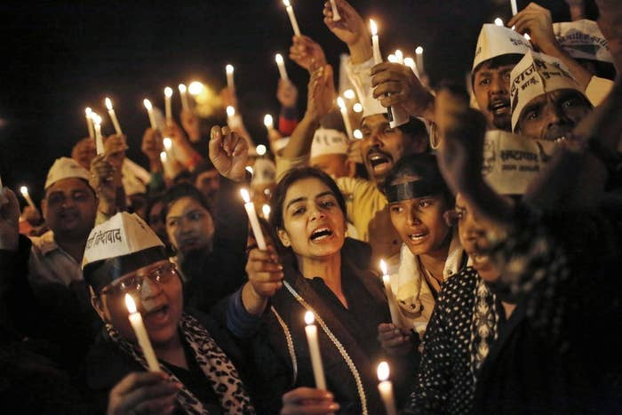 People participate in a candlelight vigil in protest of the rape of a female Uber passenger on Dec. 8.