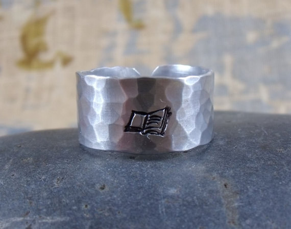 Hand hammered aluminum ring with book imprint.$20
