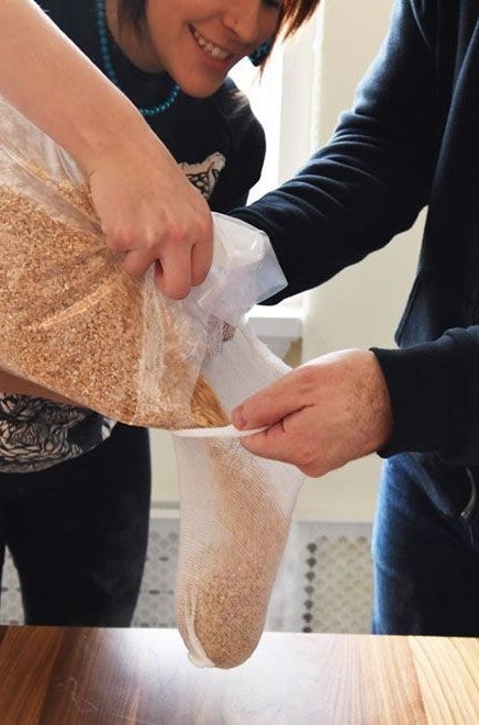 Putting grain in a steeping bag