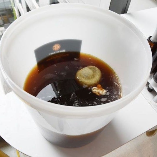 Put the fermenter with your beer in it on a kitchen counter