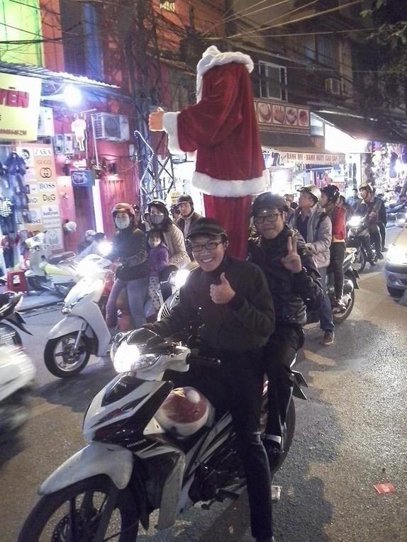 Here is the caption for this--apparently the question was "What's your favorite Christmas picture you've ever taken?" "Mine is a shot of two guys riding around Hanoi on a motorscooter ... along with a headless, life-seized, gyrating animatronic Santa Claus."