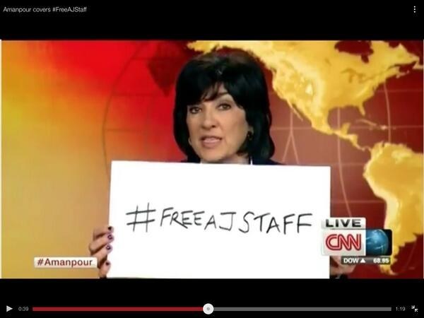 Christiane Amanpour (@camanpour) holds up #FreeAJStaff sign on-air.